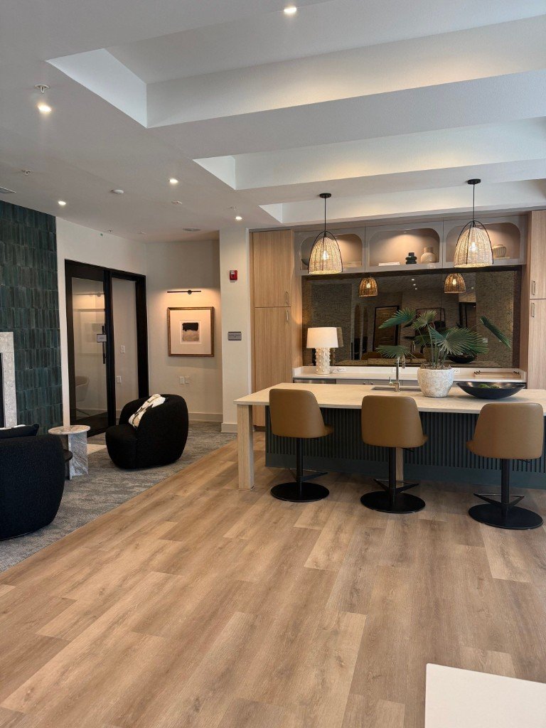 Open-concept living and kitchen with island, bar seating, and lounge area